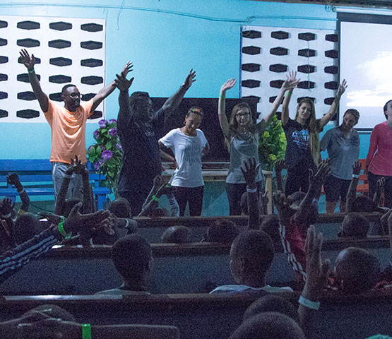 A group of New Life Staff getting children energized in a church