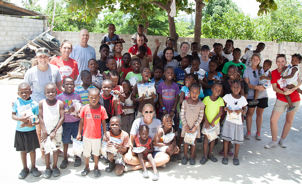 A group photo of New Life Staff with the children they are helping